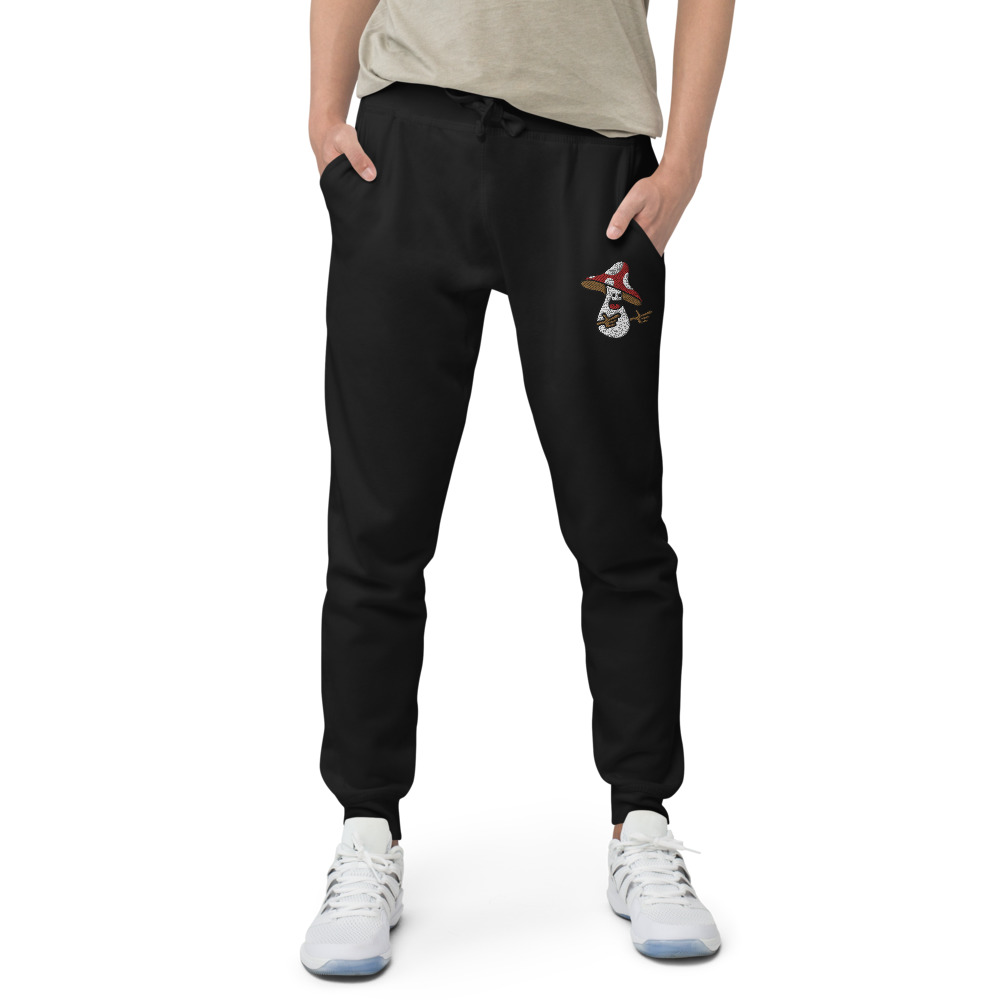 Black Joggers With an Embroidered Mushroom Making Finger Guns